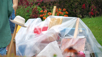 Street trade. The paintings are covered with cellophane from the summer rain.