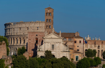Obraz premium August 21, 2021 Late afternoon view of the Santa Francesca Romana church with the Colosseum in Rome Italy
