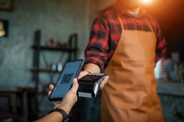 Paying through smartphone using NFC technology,Customer using his smartphone to paying with cashless wallet of e-money for POS card reader,Buy and sell products & service.