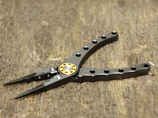 Obraz premium pliers with sharp nippers and narrow jaws on wooden background close-up