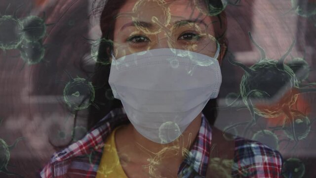 Animation of covid 19 cells moving over woman in face mask