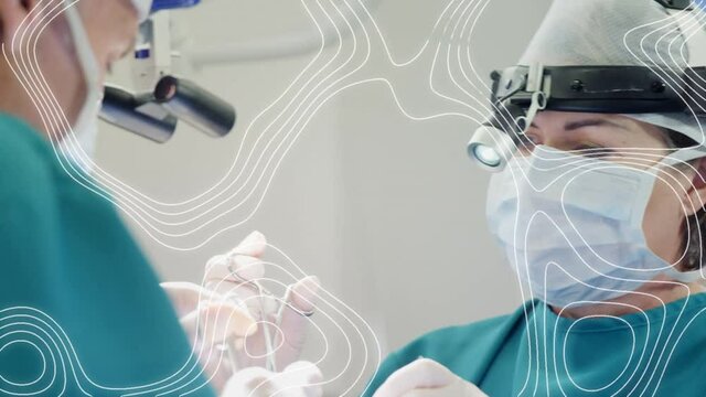 Animation of moving lines over surgeons in face masks