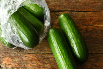 A top view image of organically grown cucumbers on an old rustic table top. 
