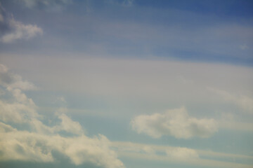 Naklejka na ściany i meble Blue sky background with blurry white clouds before sunset