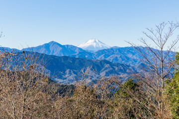 beautiful winter scenery of snow-covered mt. fuji and mountain range from takao mountain on january first in tokyo, japan