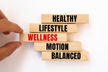 WELLNESS - Healthy lifestyle, motion balanced - concept text on wooden blocks