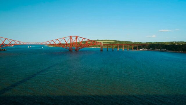 Wide view of the Firth of Forth in Scotland, UK, featuring the Forth Railway Bridge, an amazing feat of Victorian engineering
