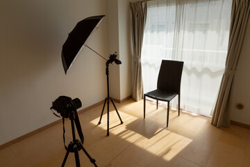camera, flash, and chair set up at mini studio in tokyo, japan