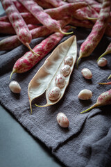 Young pods of red beans with napkin on a dark stone background close up. Healthy food. Diet concept