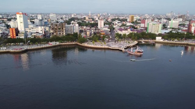 Makassar, South Sulawesi, Indonesia - Aerial Drone 99 Domes Mosque, SkyScrapers City scape and Losari Bay
