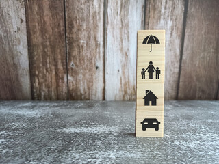 Symbol of insurance coverage on wood block concept.