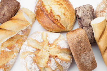 Assortment of fresh bread on white background