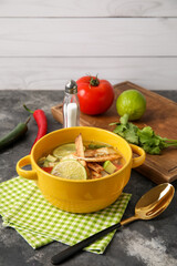 Bowl of tasty Sopa de Lima soup on table