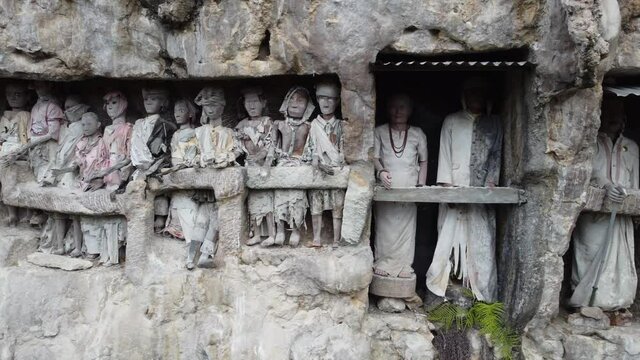 Toraja, South Sulawesi, Indonesia - Tau Tau, Effigy Made of Wood Bamboo and Stone Graves of Tana Toraja, Burial Sites Carved into Rocky Cliffs