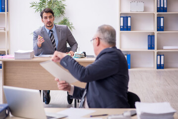 Two male employees working in the office