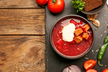 Composition with tasty borscht on wooden background