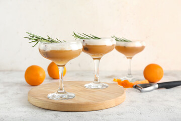 Glasses of tasty whiskey sour cocktail on grunge background