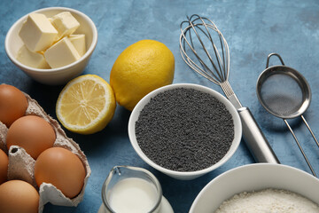 Ingredients for delicious muffins with poppy seeds on color background