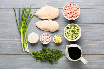 Different ingredients for okroshka on dark wooden background