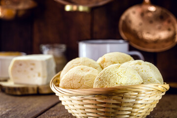 Brazilian cheese bread basket, with cheese in the background and coffee, a Brazilian tradition