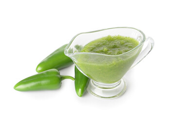 Jug of Tomatillo Salsa Verde sauce and jalapeno pepper on white background