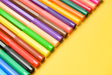 Colorful markers on color background