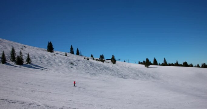 Panning Shot Of People Skiing Over Snow Covered Landscape Against Clear On Sunny Day During Vacation - Vail, Colorado