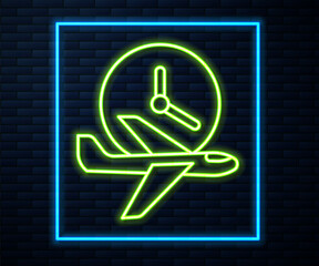 Glowing neon line Flight time icon isolated on brick wall background. Vector