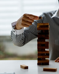 Close up of Hand stopping wooden domino business crisis effect or risk protection concept