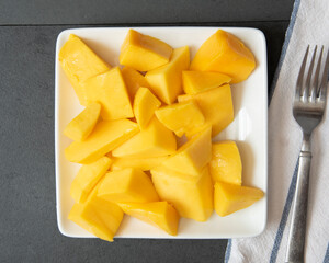 Fresh ripe mango slices tropical fruit on a plate