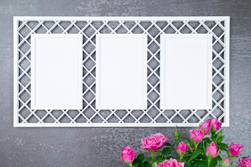 Obraz premium Openwork frame with 3 windows and a bouquet of roses on a dark background for mockup