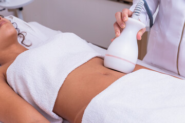 woman doing lipocavitation in the clinic