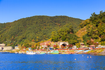 Fototapeta premium Lake side road of Kawaguchi town, viewed from ferry, Kawaguchigo, Japan.