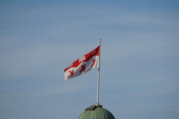 Montreal, QC, Canada - 8-4-2021: Isolated flag of McGill university flies in the air in a windy day with a background of a clear blue sky. First back to school in Fall 2021 since covid-19