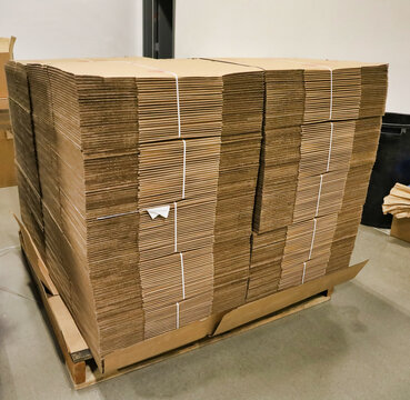 Picture of a stack of flat cardboard boxes bundled together.