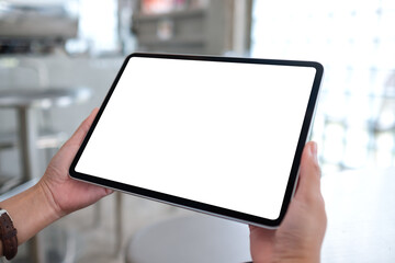 Mockup image of a woman holding digital tablet with blank white desktop screen