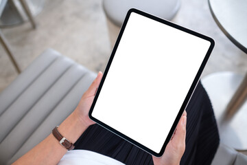 Top view mockup image of a woman holding digital tablet with blank white desktop screen