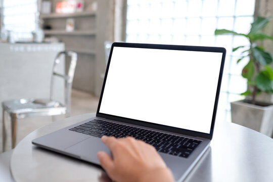Mockup image of a woman using and working on laptop computer with blank white desktop screen