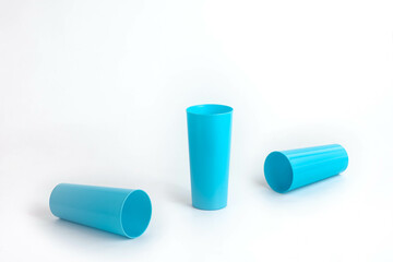 Spilled blue plastic cup isolated on white background