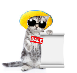 Cute kitten wearing sunglasses and tiny summer hat holds sales symbol and shows empty list. isolated on white background