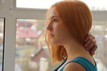 Pensive young woman with ginger hair