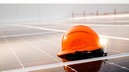 helmet and light bulb.Photovoltaic panels on the roof. Renewable clean green energy.