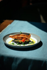 Gourmet salmon fillet with creamy basil sauce and black rice