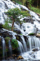 Flowing water in long exposure of tropical rainforest in Thailand.