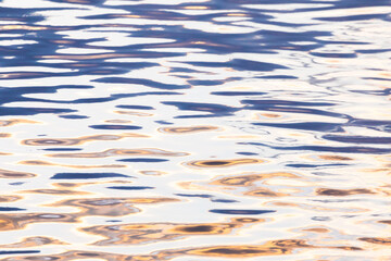 Abstract natural scene of blue and orange water surface.