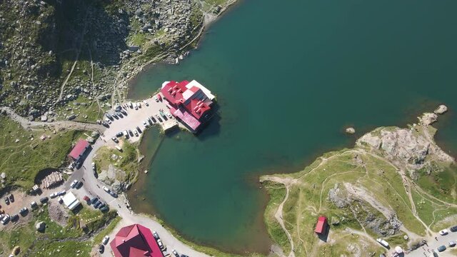 Beautiful aerial of lakeside hotel at blue lake near Transfagarasan Road, Romania