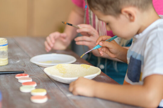 workshop for kids. Children learning how to use clay for making beautiful dishes. Workshop, master class.