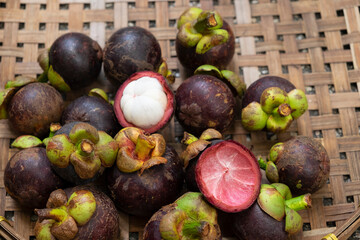 organic fresh mangosteen peeled ready to eat place on bamboo basketry tray