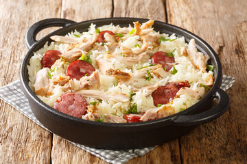 Chicken bog is a Carolina style one-pot chicken and rice dish closeup in the pan on the table. Horizontal