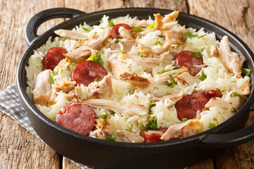 Chicken bog is a delicious chicken, rice and sausage dish closeup in the pan on the table....